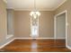 Formal dining room boasting hardwood floors and traditional chandelier lighting at 5917 Sentinel Dr, Raleigh, NC 27609