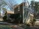 View of this wonderful two-story home with an exterior showcasing green siding and lots of beautiful windows at 5917 Sentinel Dr, Raleigh, NC 27609