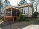 Green home exterior featuring a screened porch and sunroom at 5917 Sentinel Dr, Raleigh, NC 27609