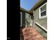 Close up view of the brick steps leading to the front door of this beautiful green home at 5917 Sentinel Dr, Raleigh, NC 27609