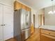 Kitchen with stainless refrigerator, light wood cabinets, and granite counters at 5917 Sentinel Dr, Raleigh, NC 27609