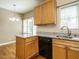 Kitchen boasts granite countertops, stainless sink and light wood cabinetry at 5917 Sentinel Dr, Raleigh, NC 27609