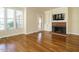 Inviting living room with hardwood floors, cozy fireplace, and built-in shelving at 5917 Sentinel Dr, Raleigh, NC 27609