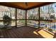 Inviting screened porch with wooden ceiling, railing, and view of the backyard at 5917 Sentinel Dr, Raleigh, NC 27609