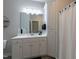 Well-lit bathroom with white cabinets, white countertops, and a shower with a curtain at 6236 Annabella Rd, Rocky Mount, NC 27803