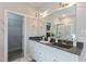 Elegant bathroom with dual sinks, granite countertop, walk-in closet, and marble shower at 6236 Annabella Rd, Rocky Mount, NC 27803