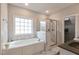 Bright bathroom with soaking tub, marble shower, and granite countertops at 6236 Annabella Rd, Rocky Mount, NC 27803