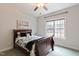 Bright bedroom with a queen bed, ceiling fan and view of the wooded landscape at 6236 Annabella Rd, Rocky Mount, NC 27803