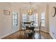 Bright breakfast nook featuring a glass table, chandelier, and large windows with backyard views at 6236 Annabella Rd, Rocky Mount, NC 27803