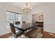 Bright dining room with contemporary chandelier, wood floors, and large windows at 6236 Annabella Rd, Rocky Mount, NC 27803