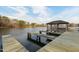 Waterfront gazebo and wooden dock on a tranquil lake, perfect for relaxation and enjoying nature's beauty at 6236 Annabella Rd, Rocky Mount, NC 27803