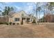 Landscaped brick home featuring a side entry garage, mature trees, and a manicured lawn at 6236 Annabella Rd, Rocky Mount, NC 27803