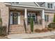 Inviting front porch featuring a classic brick facade, rocking chairs, and seasonal floral wreath on door at 6236 Annabella Rd, Rocky Mount, NC 27803