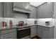 Modern kitchen with stainless steel appliances, grey cabinets, granite counters, and subway tile backsplash at 6236 Annabella Rd, Rocky Mount, NC 27803
