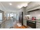 Open kitchen with stainless steel appliances, grey cabinets, granite counters, and breakfast nook in the background at 6236 Annabella Rd, Rocky Mount, NC 27803