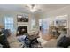 Open-concept living room with a fireplace, access to dining area, and a view into the kitchen at 6236 Annabella Rd, Rocky Mount, NC 27803