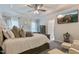 Cozy primary bedroom with a ceiling fan, tray ceiling, and an en-suite bathroom at 6236 Annabella Rd, Rocky Mount, NC 27803