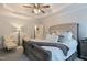 Comfortable main bedroom with sitting area, neutral colors, and a ceiling fan at 6236 Annabella Rd, Rocky Mount, NC 27803