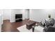 Finished basement featuring a dark leather sofa, ottoman, neutral rug and dark wood style flooring at 624 Metro Station, Apex, NC 27502