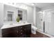 Bathroom with double sinks, dark wood cabinets, walk-in shower and separate room for the toilet at 624 Metro Station, Apex, NC 27502