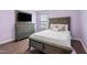 Cozy bedroom with a wooden bed frame, dresser, and light purple walls at 624 Metro Station, Apex, NC 27502