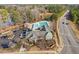 Scenic aerial view of community clubhouse and pool surrounded by lush trees and greenery, showcasing community amenities at 624 Metro Station, Apex, NC 27502