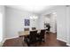 Charming dining room with modern chandelier, table with seating for six, and stylish dark wood floors at 624 Metro Station, Apex, NC 27502