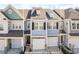 Charming townhome featuring light blue siding, a one-car garage, and well-maintained landscaping at 624 Metro Station, Apex, NC 27502
