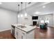 Open kitchen with an island featuring granite countertops, stainless steel appliances, and pendant lighting at 624 Metro Station, Apex, NC 27502