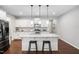 Modern kitchen with a large island, granite countertops, stainless appliances, and ample storage space at 624 Metro Station, Apex, NC 27502