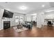 Inviting living room featuring a cozy fireplace, hardwood floors, and comfortable seating at 624 Metro Station, Apex, NC 27502