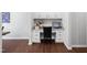 Cozy office space with granite counters, white cabinetry and dark wood floors for a clean look at 624 Metro Station, Apex, NC 27502