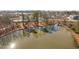 Picturesque aerial view of a pond reflecting trees and the surrounding landscape; community pool in the background at 624 Metro Station, Apex, NC 27502