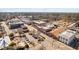 Aerial view of the town showcasing shops, street parking, and tree-lined streets in a walkable community at 624 Metro Station, Apex, NC 27502