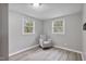 Bedroom with neutral walls, modern flooring, and chair by bright windows at 700 Ross Rd, Lillington, NC 27546