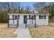 Inviting front porch with updated railings and room for seating, providing a cozy outdoor space at 700 Ross Rd, Lillington, NC 27546