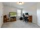This bedroom features comfortable carpeting and is complete with television and computer at 708 Barley Green St, Wake Forest, NC 27587
