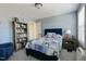 Inviting bedroom with a quilted bed, blue walls, and a full bookcase at 708 Barley Green St, Wake Forest, NC 27587