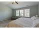 Bedroom with a large window, blue walls, and a comfortable bed, creating a serene and peaceful atmosphere at 708 Barley Green St, Wake Forest, NC 27587