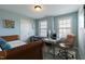 Bedroom featuring a desk with dual monitors, a woven daybed and a neutral color scheme at 708 Barley Green St, Wake Forest, NC 27587