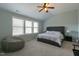 Inviting bedroom with natural light, light green walls, and a comfortable gray upholstered bed and beanbag chair at 708 Barley Green St, Wake Forest, NC 27587