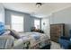 Bright bedroom with a comfortable bed, blue walls, and a wooden dresser at 708 Barley Green St, Wake Forest, NC 27587