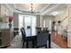 Open dining room with stylish decor, large windows, and seamless flow into the foyer and other living spaces at 708 Barley Green St, Wake Forest, NC 27587