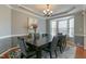 Inviting dining room featuring a tray ceiling, a large table, and a bright bay window with natural lighting at 708 Barley Green St, Wake Forest, NC 27587