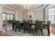 Spacious dining room with tray ceiling, chandelier, wainscoting, and a large table with seating for eight at 708 Barley Green St, Wake Forest, NC 27587