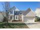 Charming two-story home with a brick facade, well-manicured lawn, and an attached two-car garage at 708 Barley Green St, Wake Forest, NC 27587