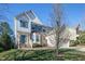 Inviting two-story home with brick accents, lush lawn, and a charming covered front entrance at 708 Barley Green St, Wake Forest, NC 27587