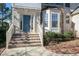 Welcoming front porch with brick steps leading to a blue front door and a bright bay window at 708 Barley Green St, Wake Forest, NC 27587