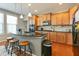 Kitchen with bar seating, updated appliances, and wood flooring at 708 Barley Green St, Wake Forest, NC 27587
