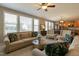 Bright and airy living room featuring a ceiling fan and large windows at 708 Barley Green St, Wake Forest, NC 27587